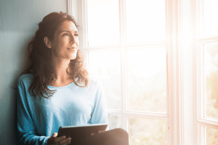 Woman by sunny window