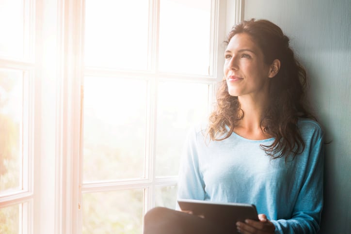 Woman by sunny window