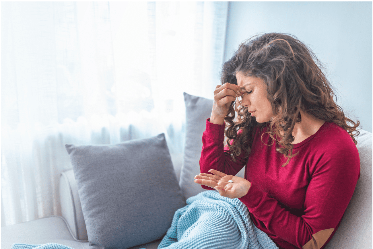 Woman taking medication for migraine