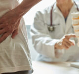 Physician showing spine model