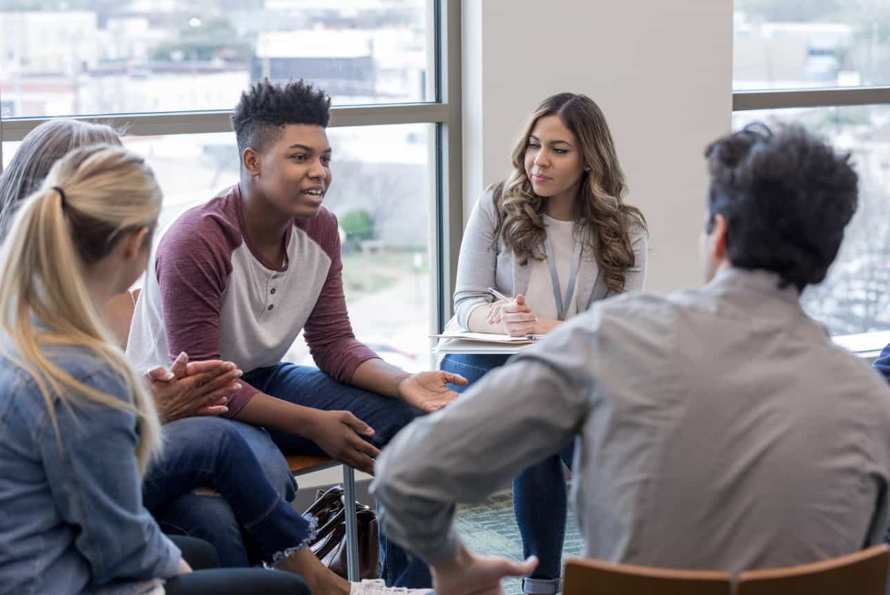 Young people in a group therapy session.