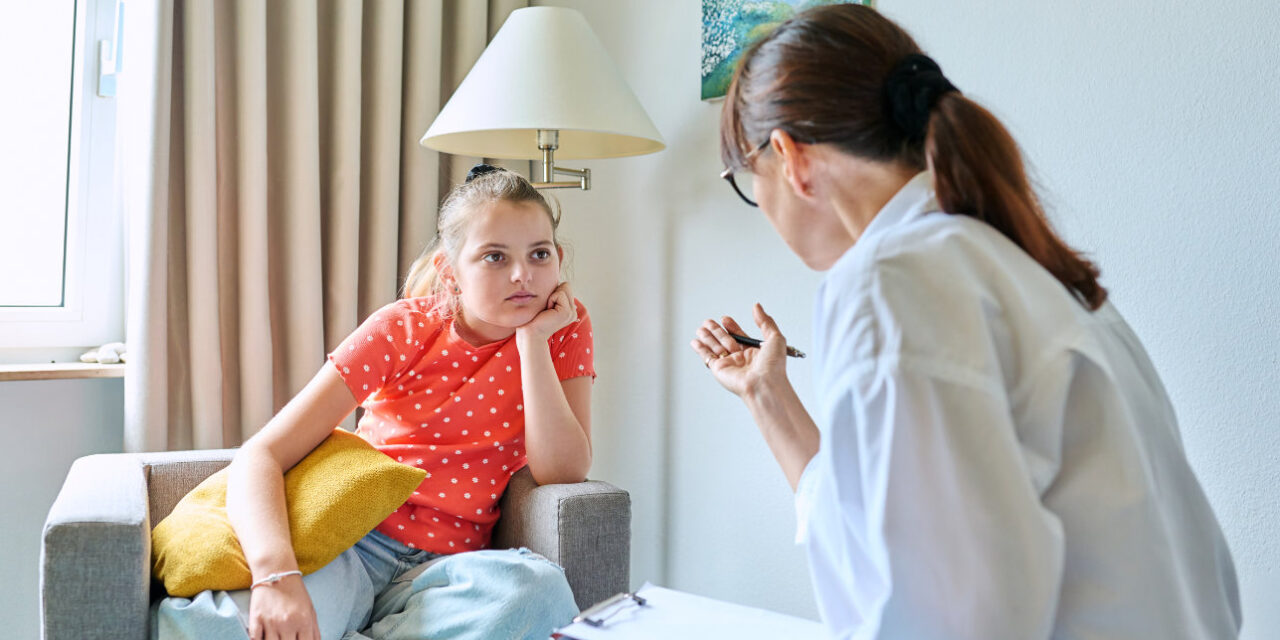 A physician speaks to a young girl